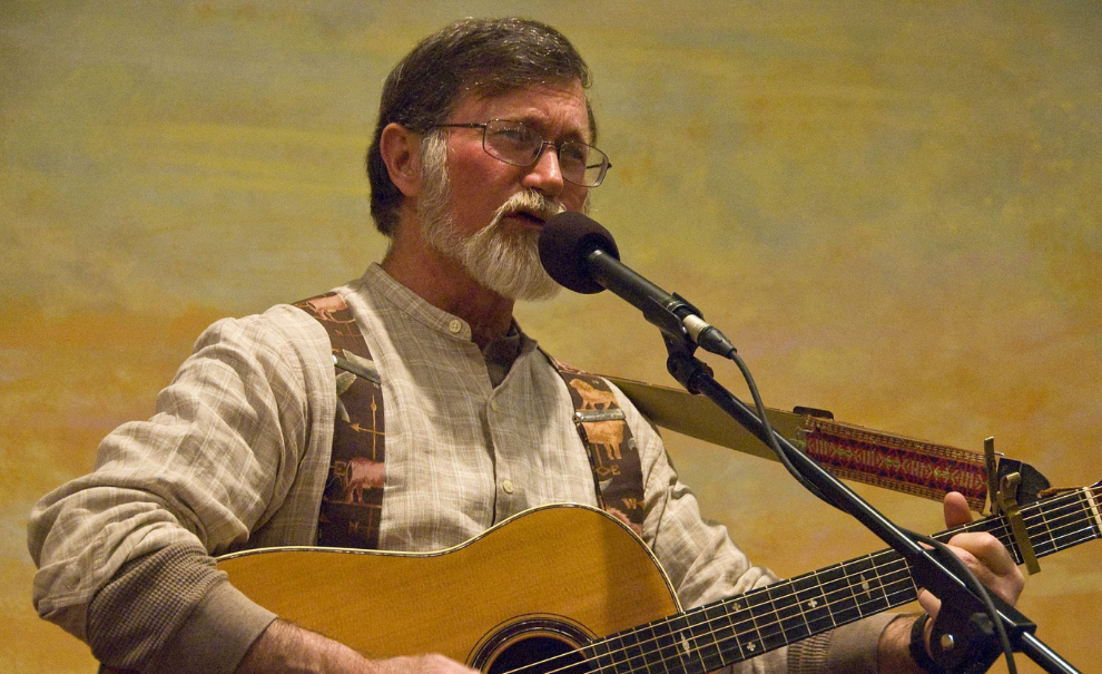 image of geoff kaufman playing guitar and singing